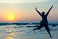 Young woman jumping with joy over the water Royalty Free Stock Photo