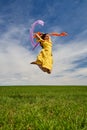 Young woman jumping for joy on a wheat field Royalty Free Stock Photo