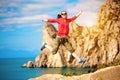 Young woman is jumping over mountain peak Royalty Free Stock Photo