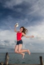 Young woman jumping at the pier Royalty Free Stock Photo