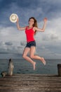 Young woman jumping at the pier Royalty Free Stock Photo