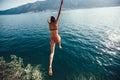 Woman jumping from a rock into the sea Royalty Free Stock Photo