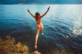 Woman jumping from a rock into the sea Royalty Free Stock Photo