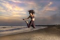 Beautiful woman trains at the beach at sunset. Royalty Free Stock Photo