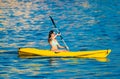 Young woman in a kanu kayak exercising in the ocean Royalty Free Stock Photo