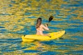 Young woman in a kanu kayak during the golden sunrise Royalty Free Stock Photo