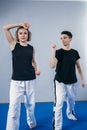 Young woman karate student with her trainer in gym. Taekwondo coach teaching adult woman in personal training. Two women