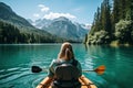 Young woman kayaking on lake Braies, Dolomites, Italy, Beautiful woman kayaking on a beautiful mountain lake with green trees, AI