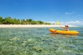 Young woman kayaking near South Sea Island, Mamanuca islands group, Fiji