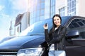 Young woman with key near car on street. Buying new auto Royalty Free Stock Photo