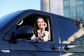 Young woman with key sitting in car. Buying new auto Royalty Free Stock Photo