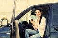 Young woman with key sitting in car. Buying new auto Royalty Free Stock Photo