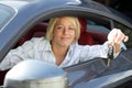 Young woman with keys of new, hire or rental car Royalty Free Stock Photo