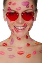 Young woman with kisses on her face and glasses, hearts Royalty Free Stock Photo