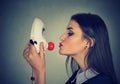 Young woman kissing clown mask Royalty Free Stock Photo
