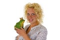 Young woman kissing a frog prince Royalty Free Stock Photo