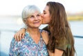 Young woman kissing her grandma