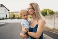 Young woman kissing her son`s forehead Royalty Free Stock Photo