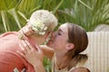 Young woman kissing little boy