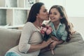 Young Woman Kissing Little Girl holding Flowers Royalty Free Stock Photo