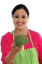 Young woman with kitchen apron holdong broccoli Royalty Free Stock Photo