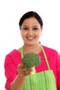 Young woman with kitchen apron holdong broccoli Royalty Free Stock Photo