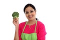 Young woman with kitchen apron holdong broccoli Royalty Free Stock Photo