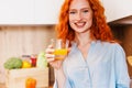 Young woman in kitchen. Beautiful woman in modern kitchen drinking orange juice. Royalty Free Stock Photo