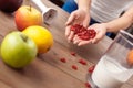 Young girl at kitchen healthy lifestyle standing holding cranberries for smoothie close-up