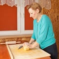 Young woman kneading dough