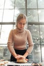 Young woman kneading dough for pie or cookies