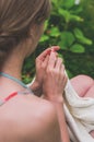 Young woman knits out of wool outdoors Royalty Free Stock Photo