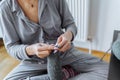 young woman knits wool product