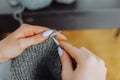 young woman knits wool product