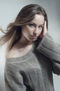 Young woman in knitted gray sweater