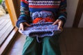 Young woman is knitting, hands of a knitter