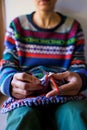 Young woman is knitting, hands of a knitter