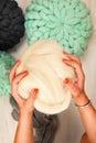 Young woman with giant merino wool in hands