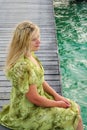 Young woman landing stage on beach on Maldives