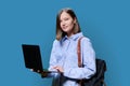 Young woman with laptop computer in hands on blue background Royalty Free Stock Photo