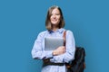 Young woman with laptop computer in hands on blue background Royalty Free Stock Photo