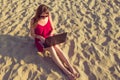 Young woman with laptop computer on the beach. Downshifting and Royalty Free Stock Photo