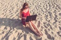 Young woman with laptop computer on the beach. Downshifting and Royalty Free Stock Photo