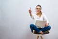 Young woman with a laptop computer pointing something Royalty Free Stock Photo