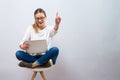 Young woman with a laptop computer pointing something Royalty Free Stock Photo