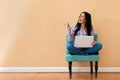 Young woman with a laptop computer pointing something Royalty Free Stock Photo