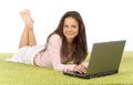 Young woman with laptop on the green carpet Royalty Free Stock Photo