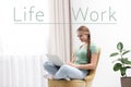 Young woman with laptop sitting in armchair. Concept of balance between work and life Royalty Free Stock Photo