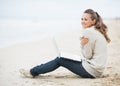 Young woman with laptop sitting on beach Royalty Free Stock Photo