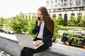 A young woman with laptop is talking on the phone Royalty Free Stock Photo